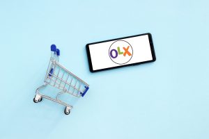 Логотип ОЛХ на телефоні та візок